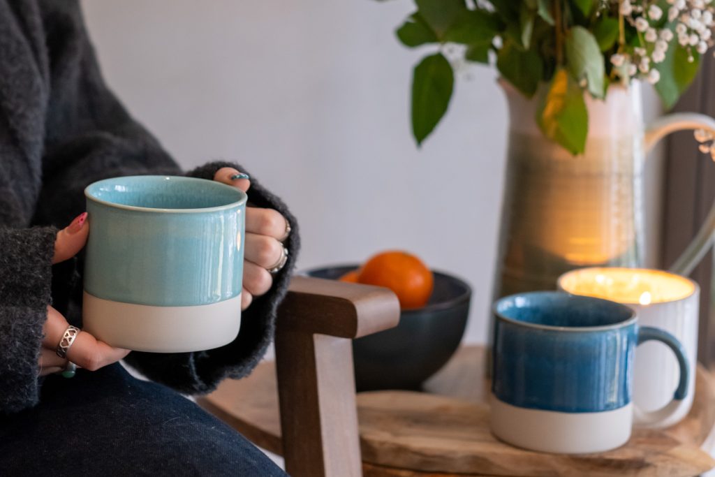 A serene moment of mindfulness as a person relaxes with a cup of tea, embodying tranquility and presence.