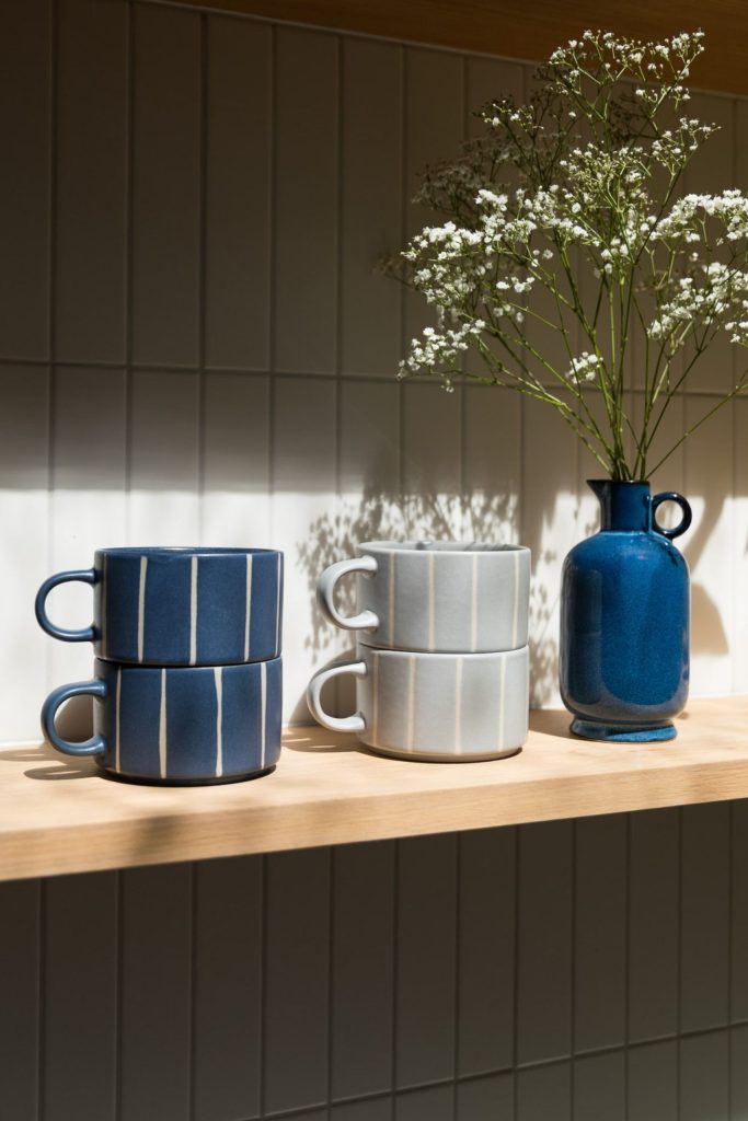 Christmas Gifts | Upper Street Home Stacked blue and grey Luna striped mugs on a kitchen shelf