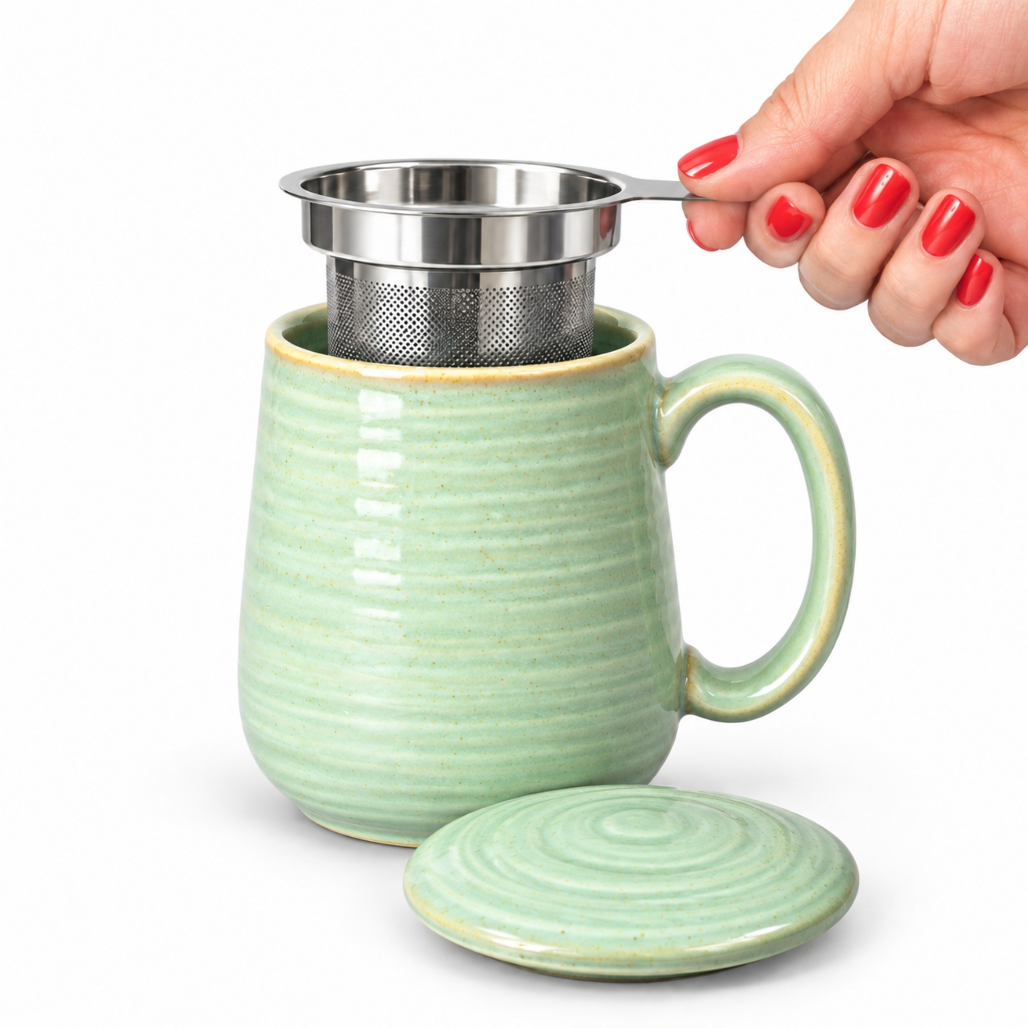 Skandi Home Aska Large Sage Green Reactive Glaze Ceramic Infuser Mug with Lid and removable Stainless Steel Infuser | Upper Street Home Skandi Home Aska large sage green reactive glaze infuser mug with the stainless steel infuser being lifted out
