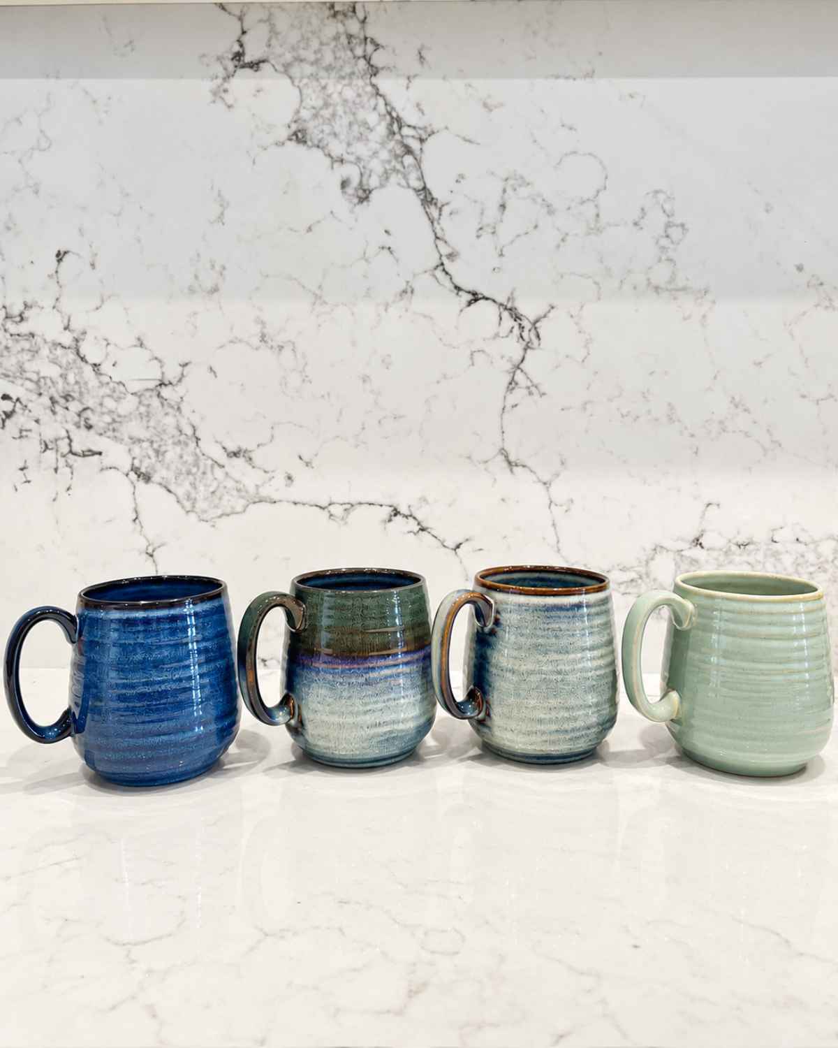 Ceramic Coffee Mugs: Why No Two Reactive Glaze Mugs Are the Same, and How to Choose Yours | Upper Street Home Four Aska reactive glaze infuser mugs side by side on a worktop